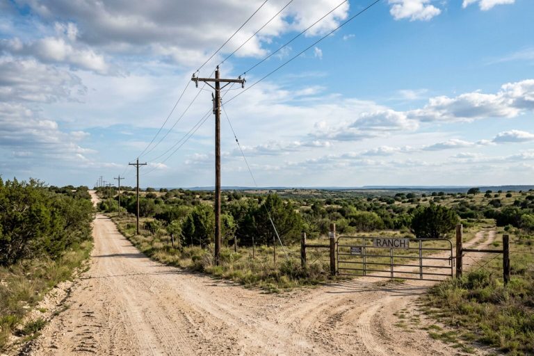 Power lines along a caliche road to rural Texas land
